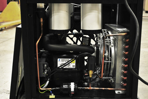  Inside view of Airbase EDRCF1150030 showcasing the refrigerated air dryer's internal components, including motors and cooling pipes.