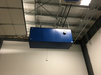 BSE AIRMAX Commercial Ambient Carbon Air Cleaner mounted on a ceiling, shown from a side angle with industrial surroundings.