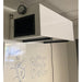 An installed BSE AIRPRO Commercial 1100 CFM Ambient Air Cleaner hangs from a ceiling in an office environment, above a whiteboard with the welcoming words "Welcome to BSE"