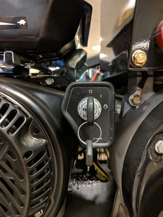 Detailed view of the electric start switch on the EMAX E450-GR gas driven air compressor and generator combo