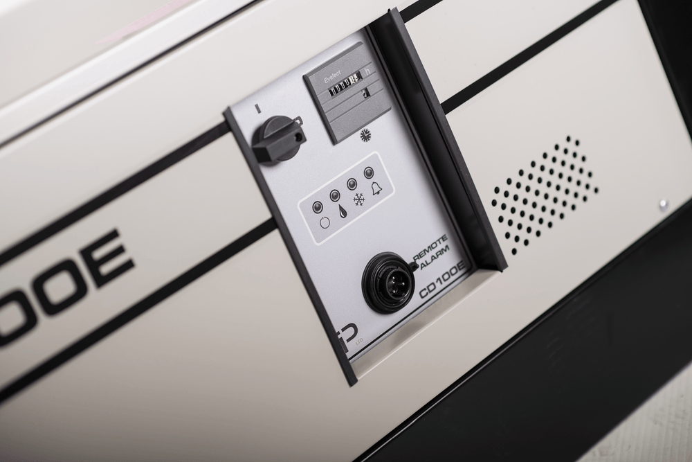 Close-up of EBac CD100E dehumidifier control panel with humidistat dial, status lights, and alarm port